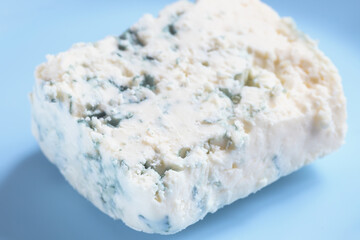 Piece of blue cheese on blue plate