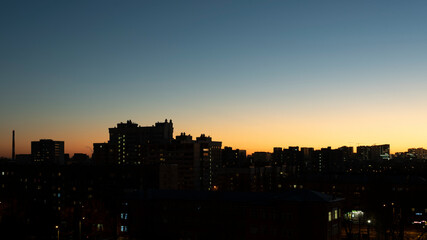 Fototapeta na wymiar Silhouettes of buildings in the sun flare. Cityscape.