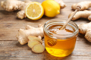 Ginger, honey and lemon on wooden table. Natural cold remedies