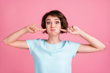 Photo of childish funny lady dressed casual blue t-shirt pointing fingers bloated cheeks isolated...