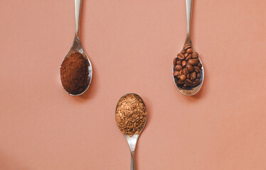 Three types of coffee in spoons in assortment: instant, ground grain and grain