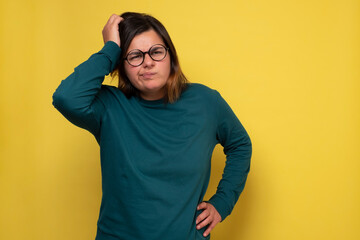 Caucasian woman with glasses having thoughtful look. Pensive female with puzzled expression...