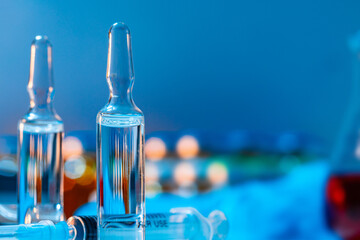 Vial of vaccine bottle with a syringe close up