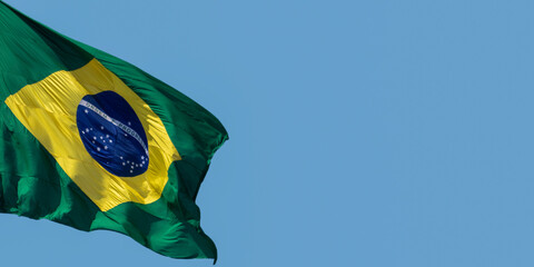 Flag of Brazil fluttering in the wind. In the center of the flag with the words "order and progress" in Portuguese © Leonidas