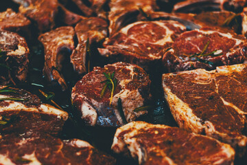 Pork steak with sprigs of rosemary in a pan close-up