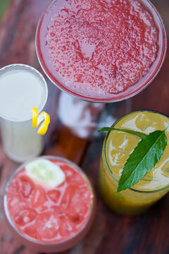 Overhead view of four cocktails on table