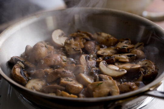 Mushrooms cooking on frying pan