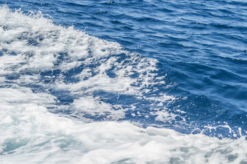 Waves of blue-white foamy sea water 