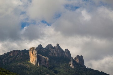 Beautiful shot of high mountains and hills covered by greenery on a sunny day