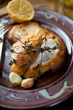 Chicken with thyme and garlic on plate