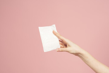 Laying in packaging in female hands on a pink background cropped view hygiene clean appearance