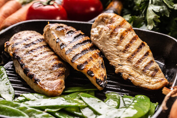 Grilled chicken breast in grill pan with sweet peas and seasoning vegetable