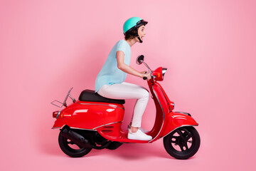 Fototapeta na wymiar Profile photo of impressed funny young lady ride moped wear white trousers sneakers blue slam t-shirt isolated on pastel pink background