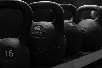 Naklejka na ściany i meble Crossfit kettlebells equipment on dark background at the crossfit gym. Sport concept