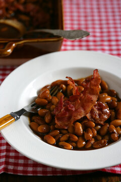Meal of bacon and beans on plate