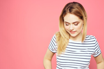 Obraz premium Woman in striped t-shirt emotions studio cropped view lifestyle pink isolated background