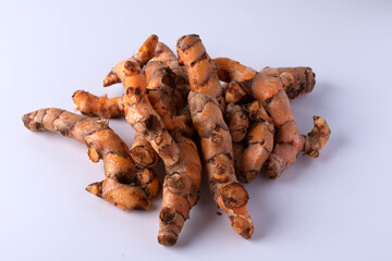 A pile of turmeric on a white background