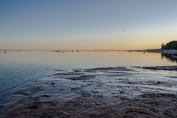 Summer sunset on the beach of the Gulf of Finland in the Leningrad region