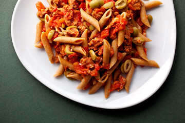 Pasta with spicy sausages, tomatoes, rosemary and olives