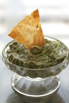 Close up of spinach and yogurt dip served with nacho chips