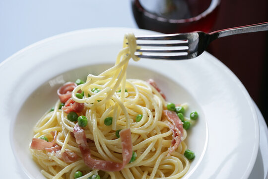 Close up of pasta with prosciutto and peas - Powered by Adobe