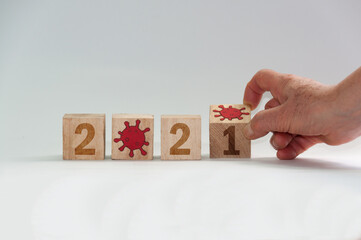 New year 2021, change from 2020 to 2021 concept, hand change wooden cubes. End of coronavirus...
