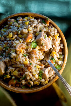 Close up of coconut barley pilaf with corn, chicken and cashews