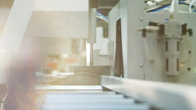 Buzzsaw cutting metal profile automatically in big warehouse/workshop 4k PRORES Footage
