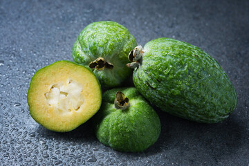 Tropical fruit feijoa (Acca sellowiana) on gray background. Healthy food.