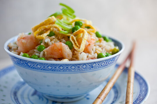 Bowl of chinese fried rice with shrimps and peas