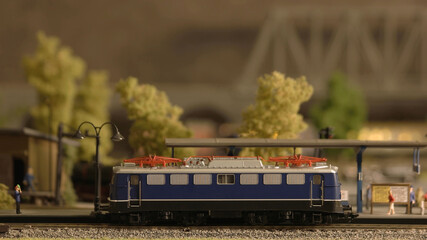 Miniature railway carriage. Plastic toy railway model with train side view.