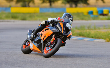 Motorcycle practice leaning into a fast corner on track