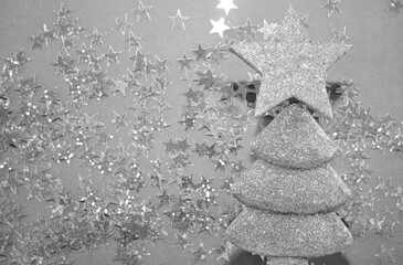 creative holiday concept: shape christmas tree  made from glitters. golden  stars on blue paper...