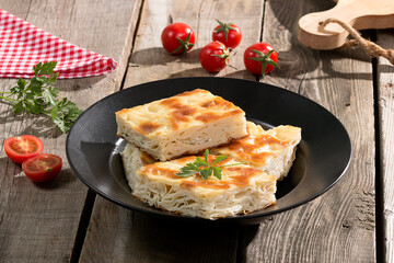Water pastry on the plate. Composition of water pastry, tomato, hot pepper and olives on old wooden table.