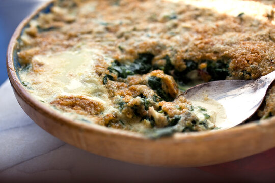 Close up of rockfish and spinach gratin in bowl