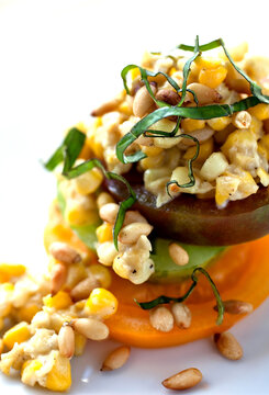 Close up of creamed corn with gorgonzola, tomatoes and pine nuts