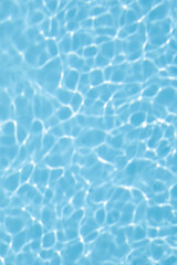 Fototapeta na wymiar Light blue water in the swimming pool with reflection, beautiful background for gift card, with space for text