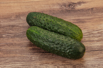 Green fresh cucumbers over background