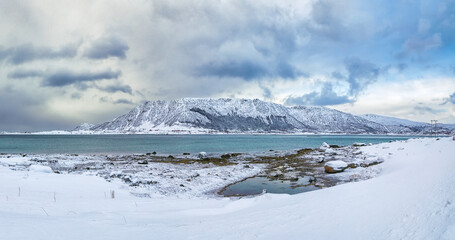 Fabulous snowy winter scene of  Vestvagoy island with snowy  mountain peaks on Lofoten Islands