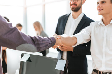 close up. young business people greeting each other with a handshake.