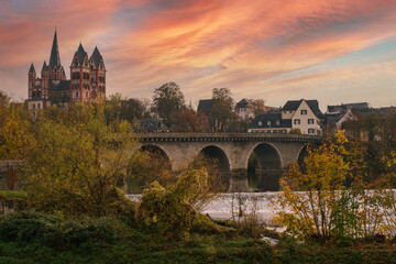 View of the cathedral in Limburg / Germany and the old Lahn bridge in autumn in the evening