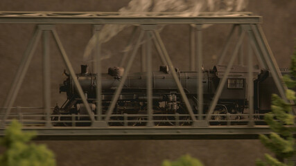 Steam lokomotive on the bridge side view. Retro miniature train with smoke.
