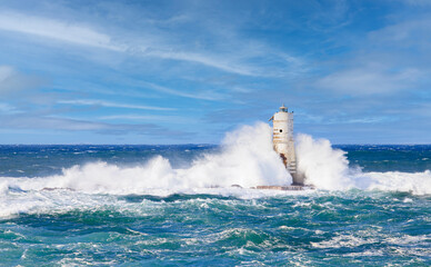 The lighthouse of the Mangiabarche shrouded by the waves of a mistral wind storm  © ivan canavera