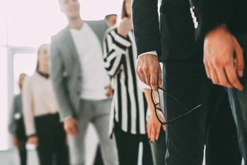 close up. young business man standing in a long queue