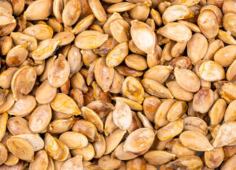 Close-up of fresh ripe pumpkin seeds pulled out.