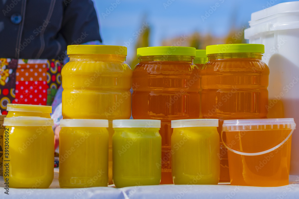 Sticker Autumn fair of Bashkir bee honey. The product is packed for sale in various containers.