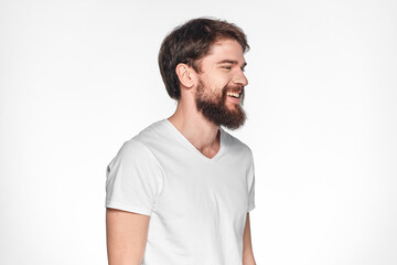 Obraz premium Bearded man in white t-shirt gesture with hands emotions light background