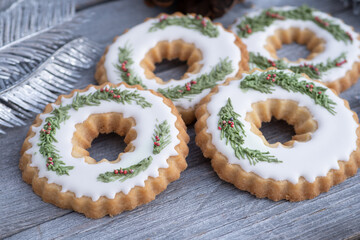Christmas cookies decorated with royal icing on wooden table