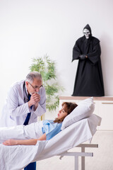 Devil, old doctor and female patient in the clinic