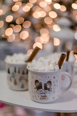 Christmas, New Year interior decorated  table with cups, marshmallows  and cinnamon
